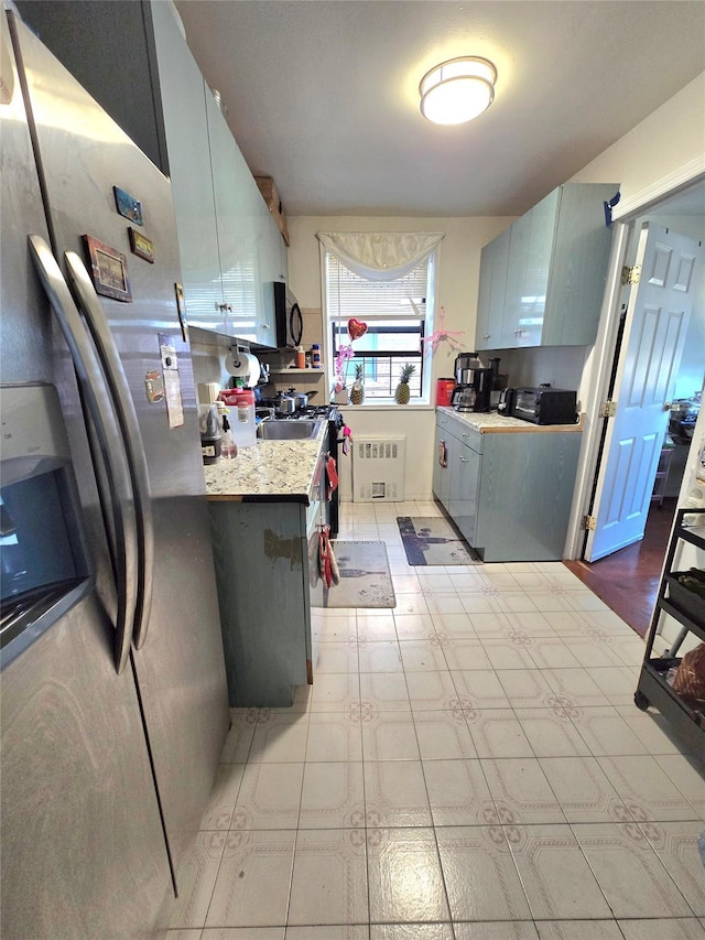 kitchen with appliances with stainless steel finishes and radiator