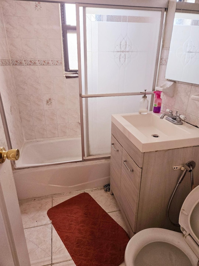 full bathroom featuring tile patterned flooring, enclosed tub / shower combo, backsplash, toilet, and vanity