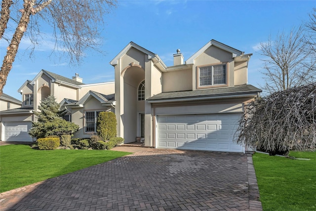 view of front of home featuring a garage and a front lawn