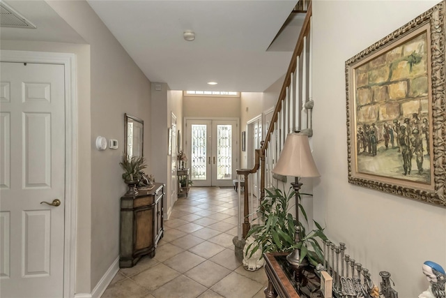 corridor with french doors and light tile patterned floors