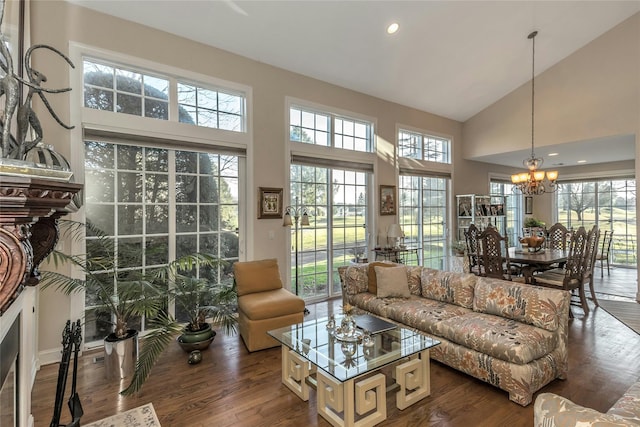 living room with plenty of natural light, high vaulted ceiling, and dark wood-type flooring