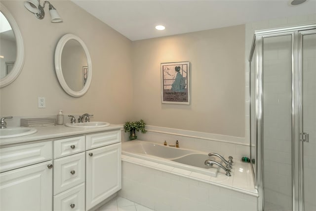 bathroom featuring tile patterned flooring, shower with separate bathtub, and vanity