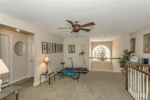 sitting room featuring ceiling fan with notable chandelier