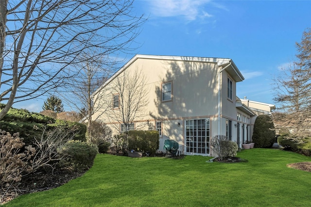 rear view of property with a lawn