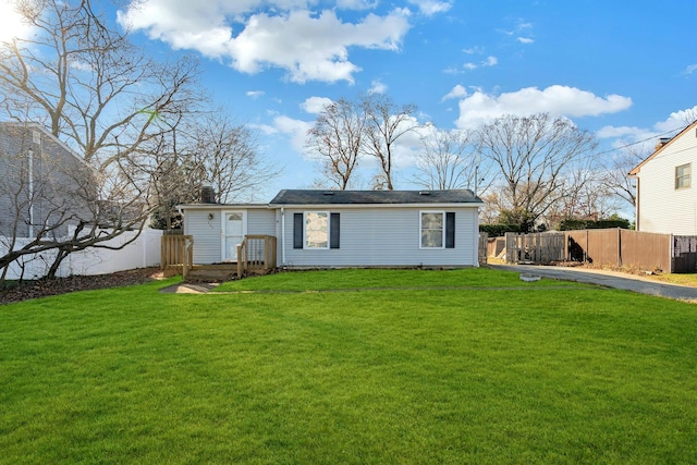 rear view of property with a lawn