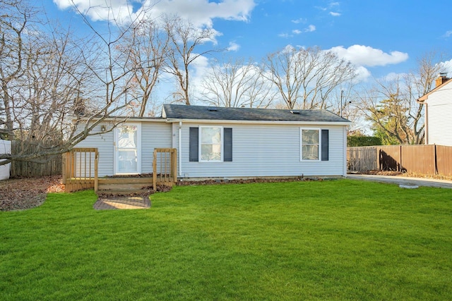 rear view of property with a lawn