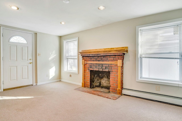 unfurnished living room with a fireplace, light colored carpet, and baseboard heating