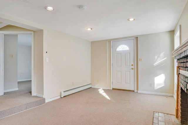 carpeted foyer entrance with a fireplace and a baseboard radiator