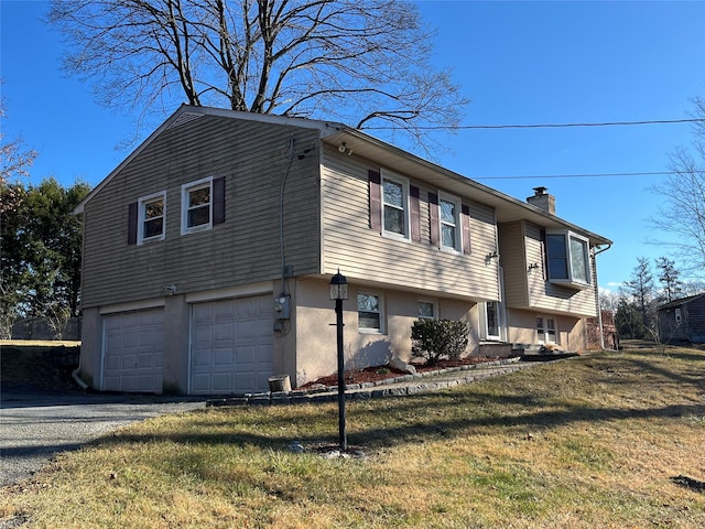 view of side of home with a lawn and a garage