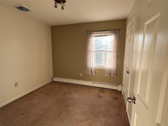 spare room featuring dark colored carpet and a baseboard radiator