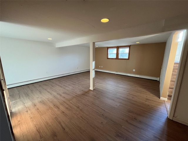 basement with hardwood / wood-style flooring and baseboard heating