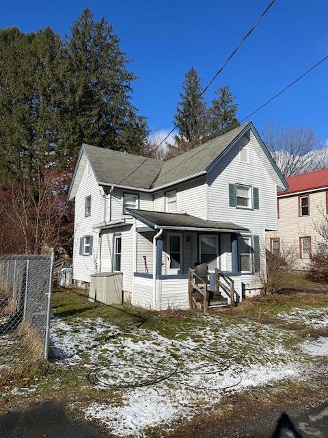 snow covered property featuring covered porch