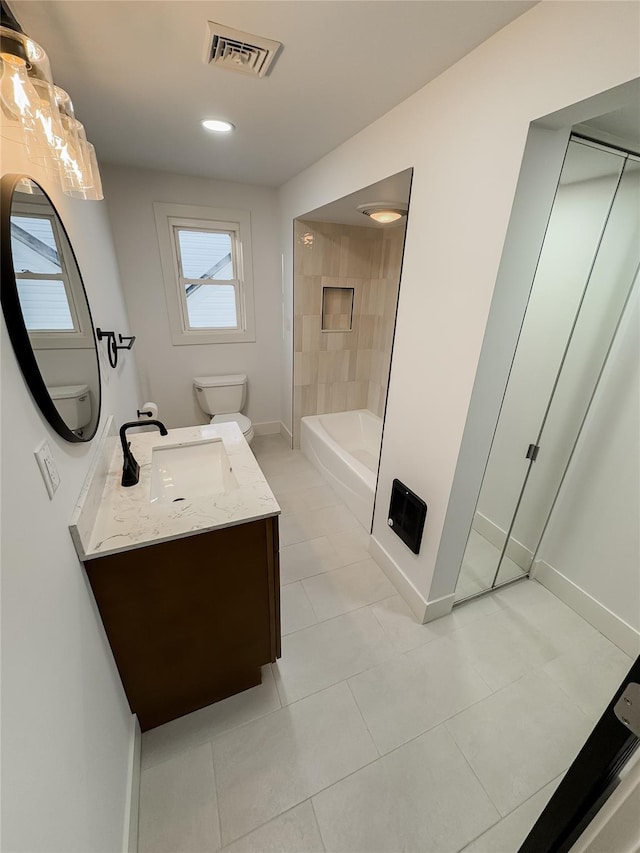 bathroom with tile patterned floors, vanity, and toilet