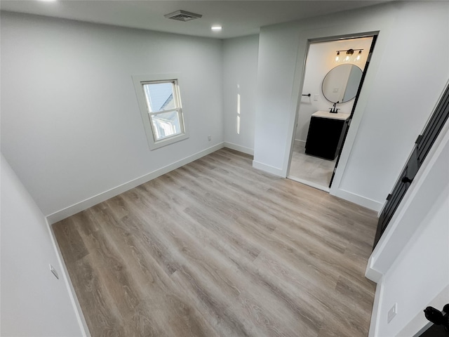 unfurnished room with light hardwood / wood-style floors