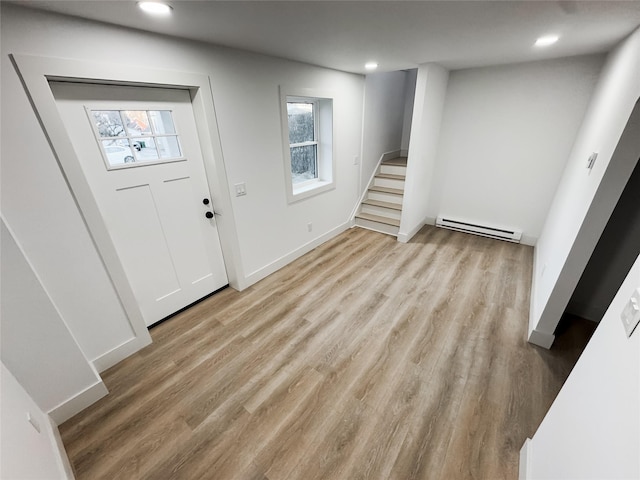 entrance foyer featuring a baseboard heating unit and light wood-type flooring