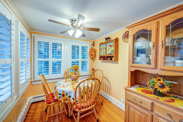 dining area with ceiling fan, light hardwood / wood-style floors, crown molding, and a baseboard radiator