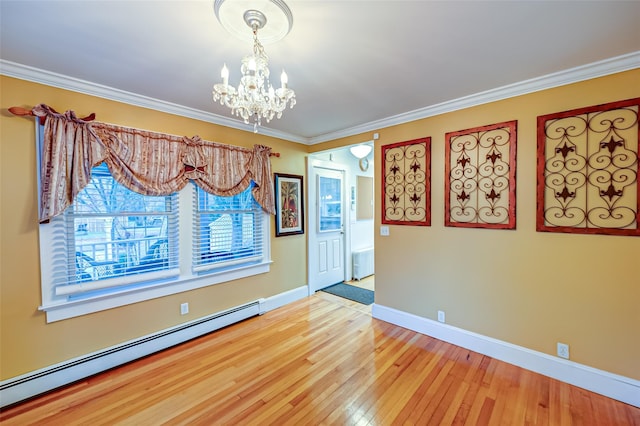 spare room featuring an inviting chandelier, wood-type flooring, ornamental molding, baseboard heating, and radiator heating unit