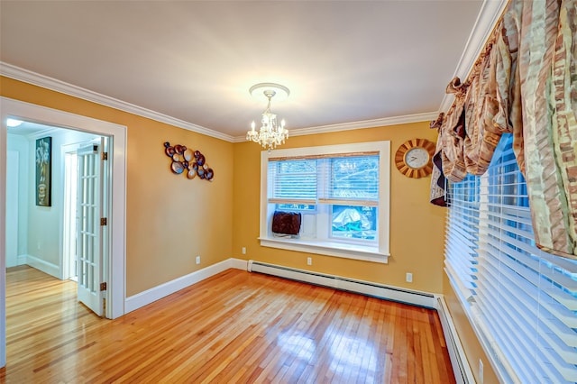 empty room featuring light wood-type flooring, a baseboard radiator, ornamental molding, and a notable chandelier