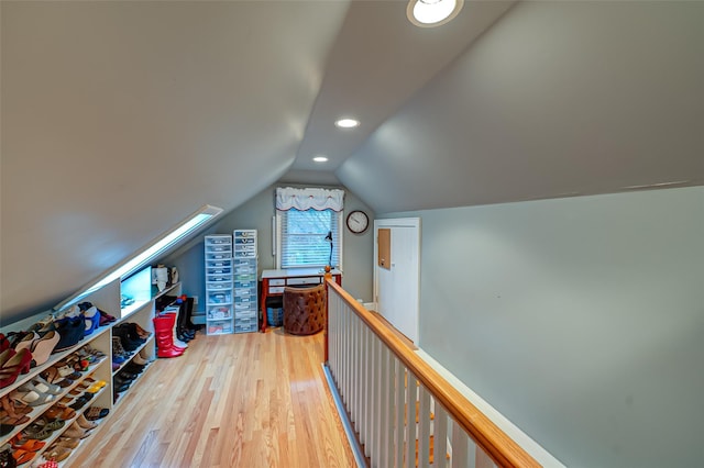 bonus room featuring vaulted ceiling and hardwood / wood-style flooring