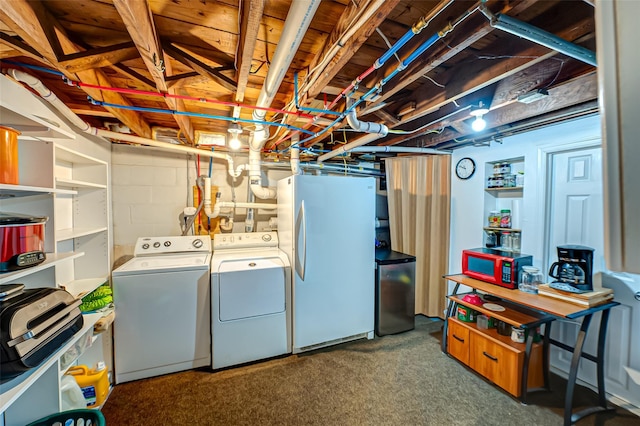 basement with stainless steel fridge, white fridge, dark carpet, and independent washer and dryer