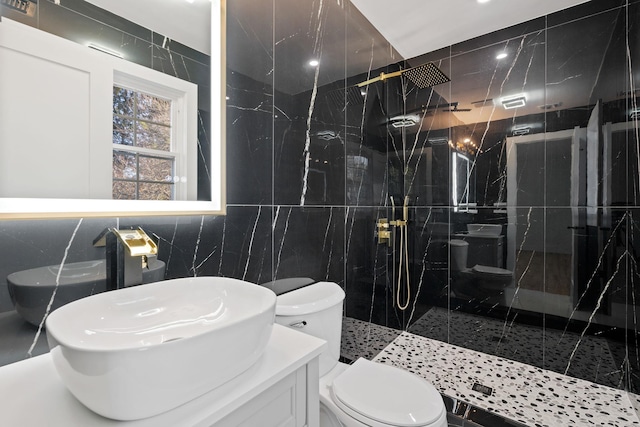 bathroom with tiled shower, toilet, tile walls, and sink