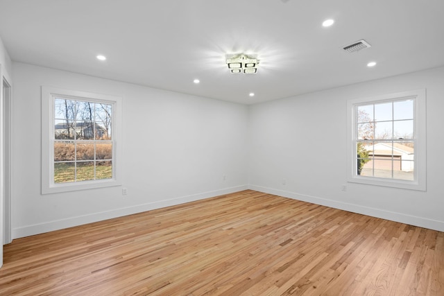 unfurnished room with a wealth of natural light and light wood-type flooring