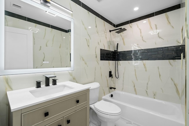 full bathroom with toilet, vanity, tile walls, and tiled shower / bath