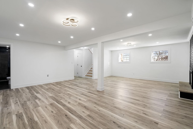 basement with light hardwood / wood-style floors