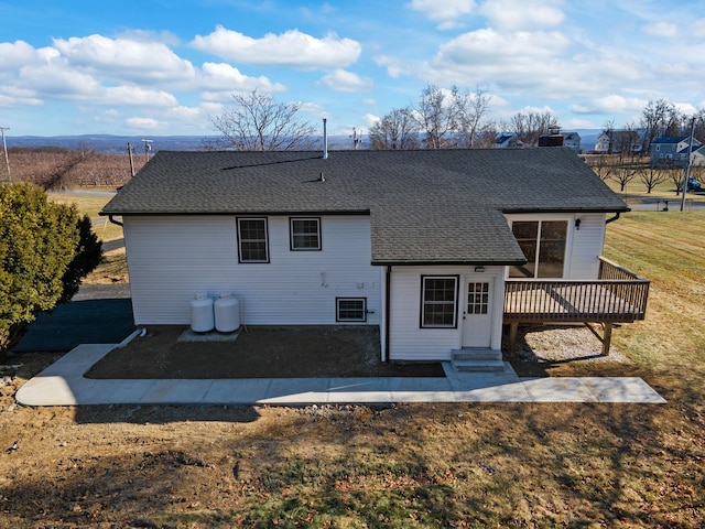 back of property featuring a yard and a deck