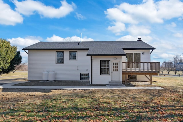 back of house featuring a deck and a yard