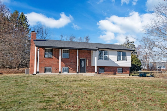 split foyer home with a front yard and central AC