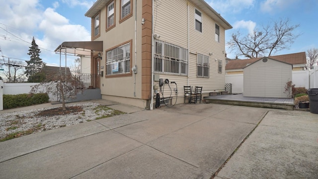 view of side of property with a storage shed