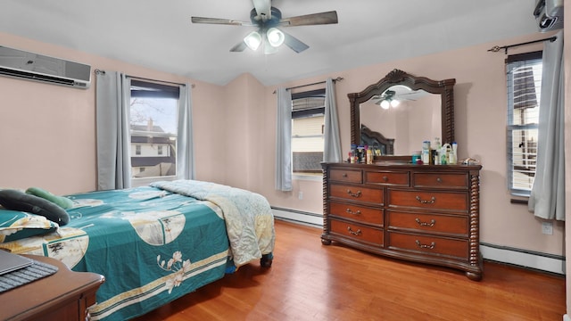 bedroom featuring ceiling fan, light hardwood / wood-style flooring, a baseboard radiator, and multiple windows