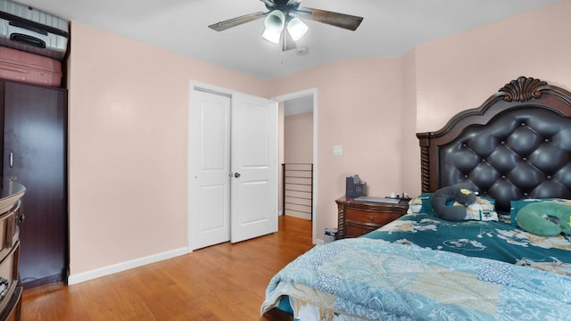 bedroom with ceiling fan and light hardwood / wood-style flooring