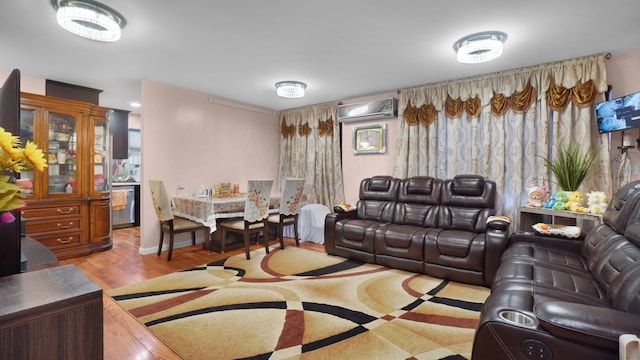 living room featuring light hardwood / wood-style floors and a wall mounted air conditioner