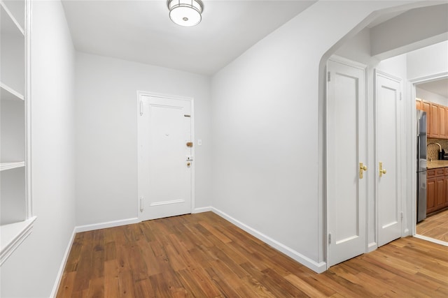 385 Argyle Rd Unit 2K, Brooklyn, NY 11218 - hall with light wood-style flooring and arched walkways