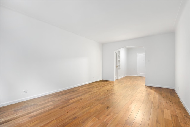 385 Argyle Rd Unit 2K, Brooklyn, NY 11218 - empty room with arched walkways and light wood-style floors