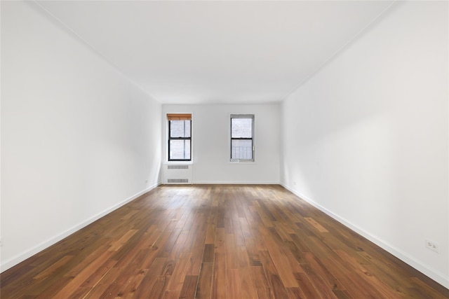 385 Argyle Rd Unit 2K, Brooklyn, NY 11218 - unfurnished room featuring dark wood-style floors and radiator heating unit