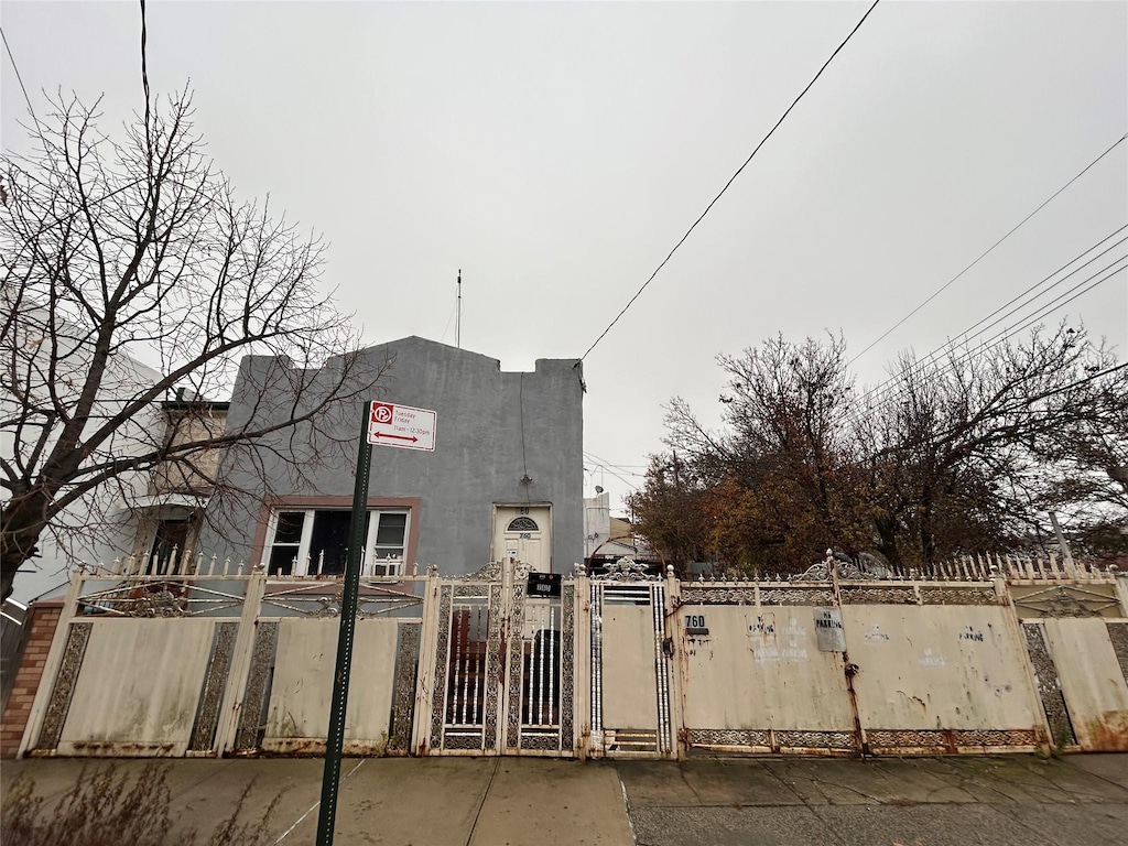 760-762 Wortman Ave, Brooklyn, NY 11208 - view of front of house featuring a gate and stucco siding