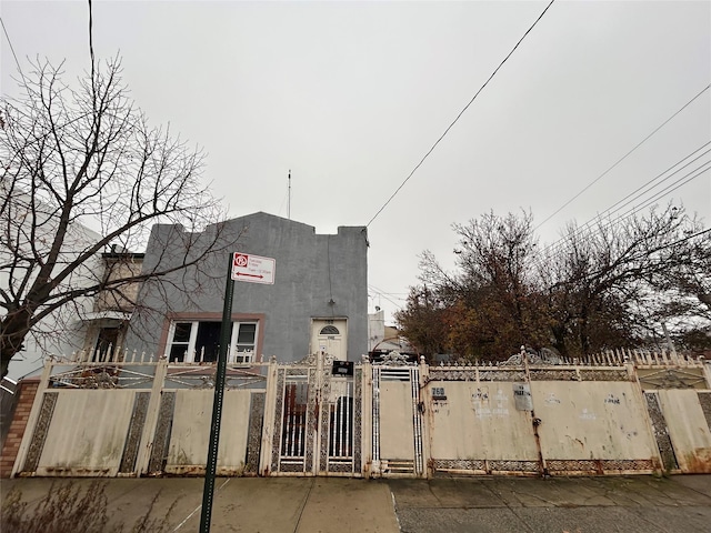 760-762 Wortman Ave, Brooklyn, NY 11208 - view of front of house featuring a gate and stucco siding
