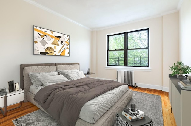 bedroom featuring radiator heating unit, crown molding, and hardwood / wood-style floors