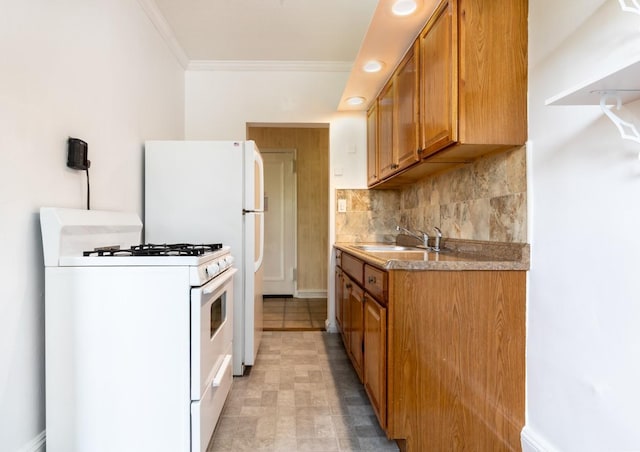 kitchen with decorative backsplash, sink, white gas range oven, and crown molding