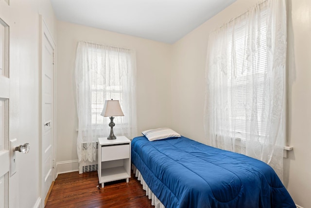 bedroom featuring dark wood-style flooring and baseboards