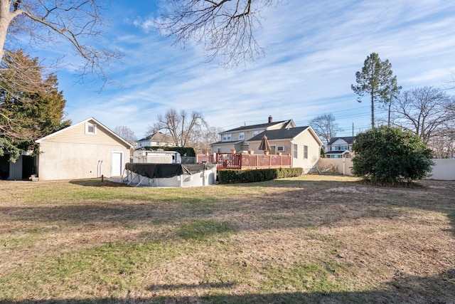 view of yard featuring a fenced in pool, fence, and a wooden deck