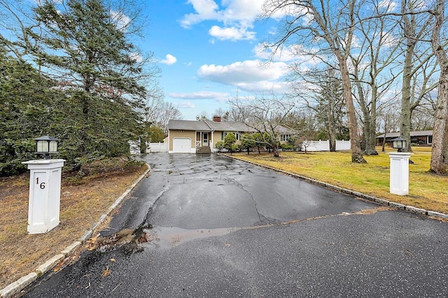 view of front of house with a garage and a front lawn