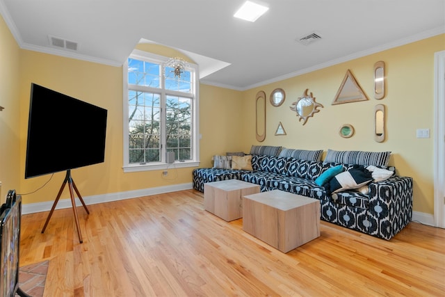 living room featuring a chandelier, crown molding, and light hardwood / wood-style floors