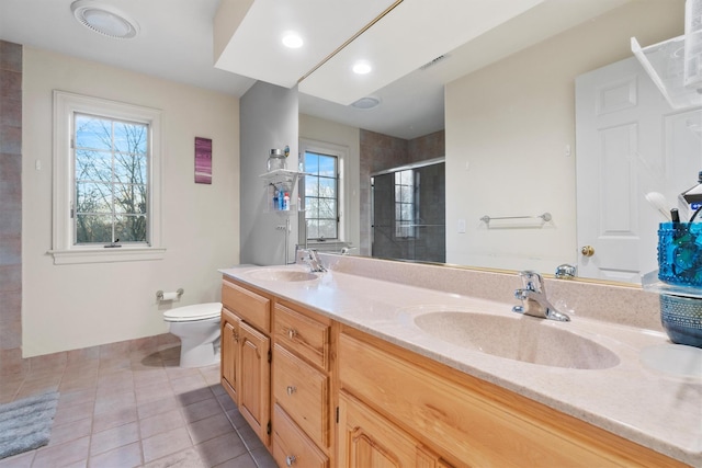 bathroom with tile patterned flooring, vanity, toilet, and plenty of natural light