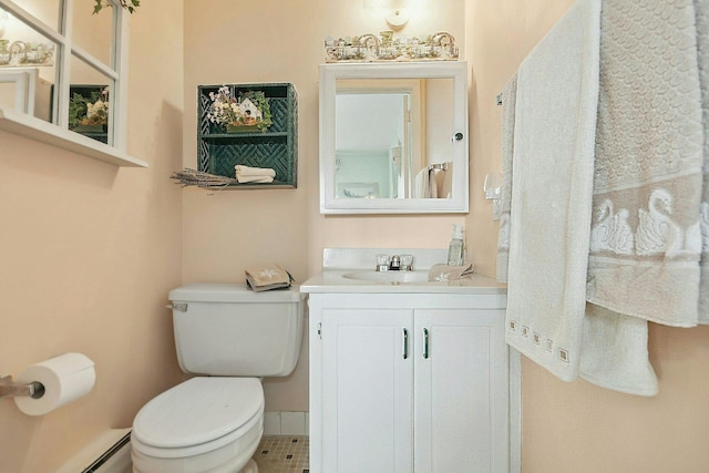 bathroom with tile patterned floors, vanity, a baseboard heating unit, and toilet