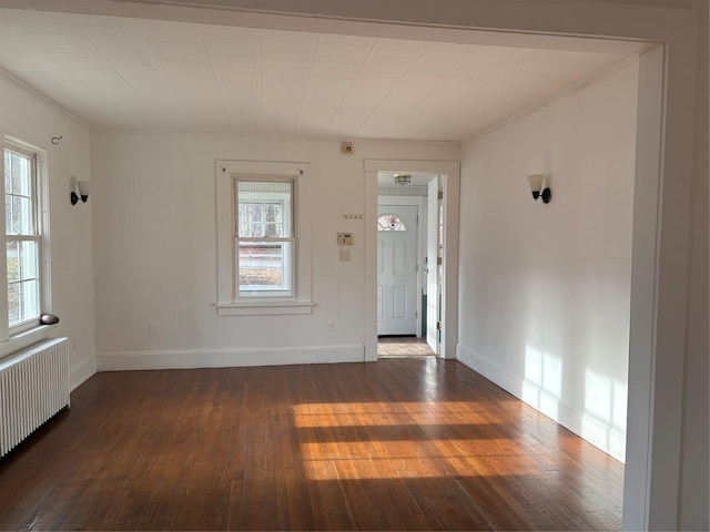 entryway featuring dark hardwood / wood-style flooring and radiator heating unit