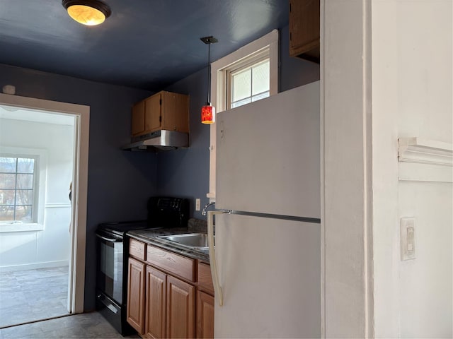 kitchen featuring pendant lighting, white refrigerator, plenty of natural light, and black / electric stove